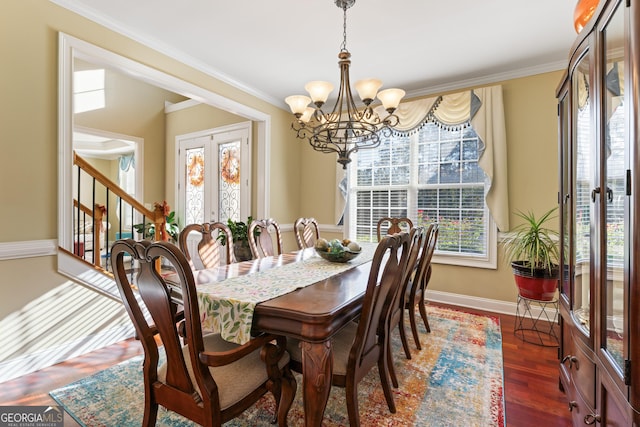 2202 Escalade Ct, Conyers, GA 30094 - dining space featuring french doors, a chandelier, stairway, ornamental molding, and dark wood-type flooring