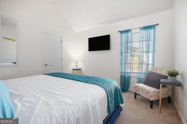 bedroom featuring lofted ceiling and light carpet