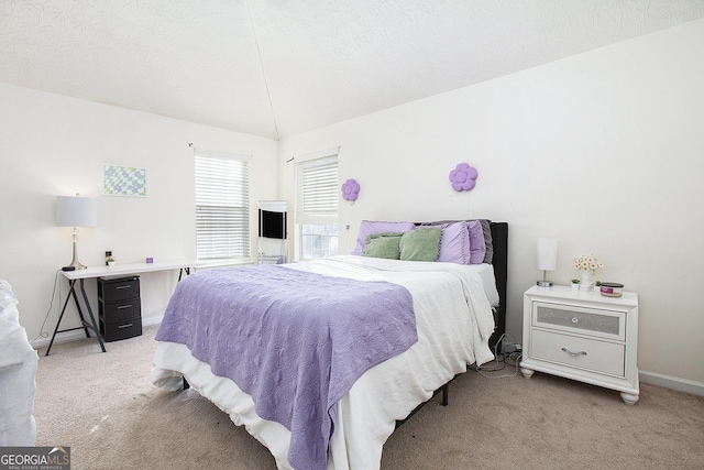 carpeted bedroom featuring a textured ceiling and baseboards