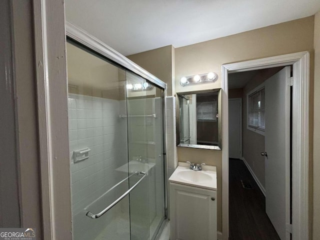 bathroom featuring vanity and an enclosed shower