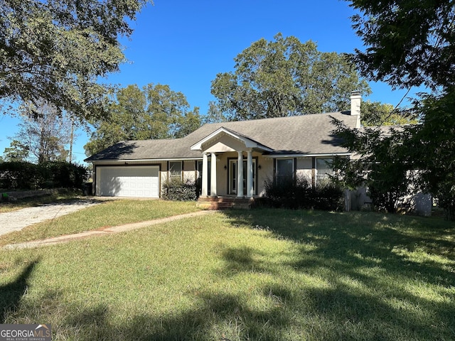 ranch-style home with a garage and a front yard