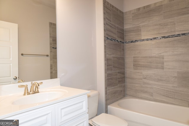 full bathroom featuring vanity, toilet, and tiled shower / bath