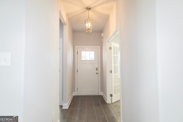 interior space featuring dark wood-type flooring and an inviting chandelier