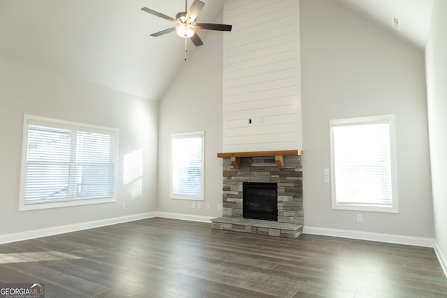 unfurnished living room with plenty of natural light, dark hardwood / wood-style flooring, and high vaulted ceiling