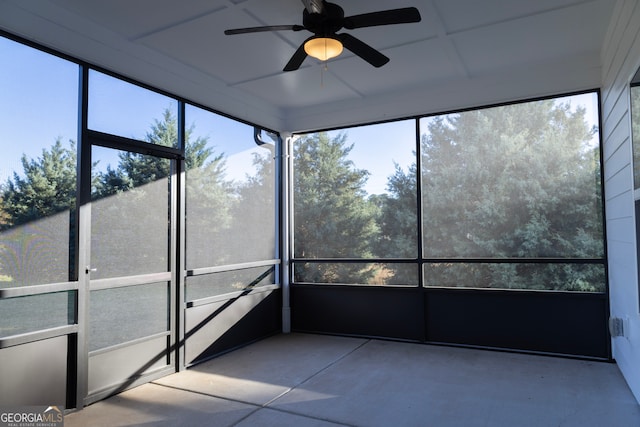 unfurnished sunroom with ceiling fan