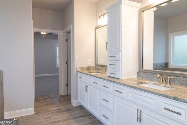 bathroom with vanity, ceiling fan, and wood-type flooring