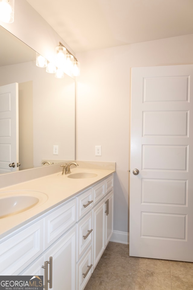 bathroom with tile patterned flooring and vanity