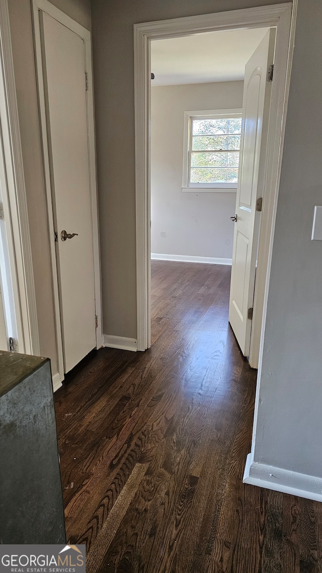 hall with dark hardwood / wood-style floors