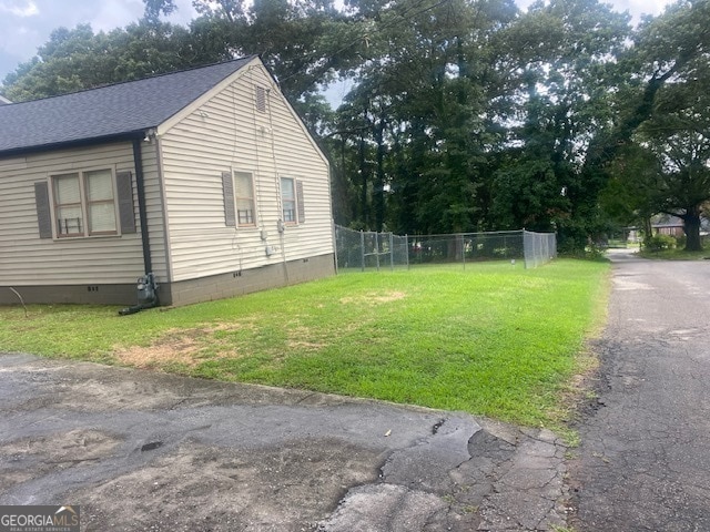 view of side of home with a lawn