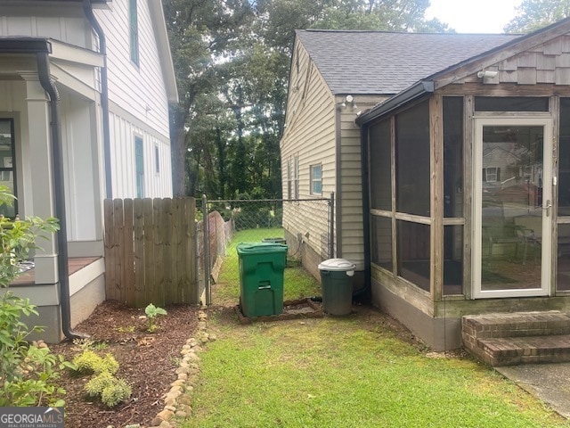 view of property exterior featuring a yard and a sunroom