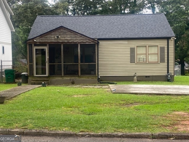 view of front of house featuring a front yard and a sunroom