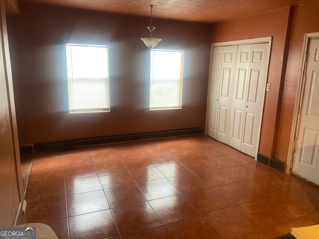 unfurnished dining area featuring tile patterned floors and a textured ceiling