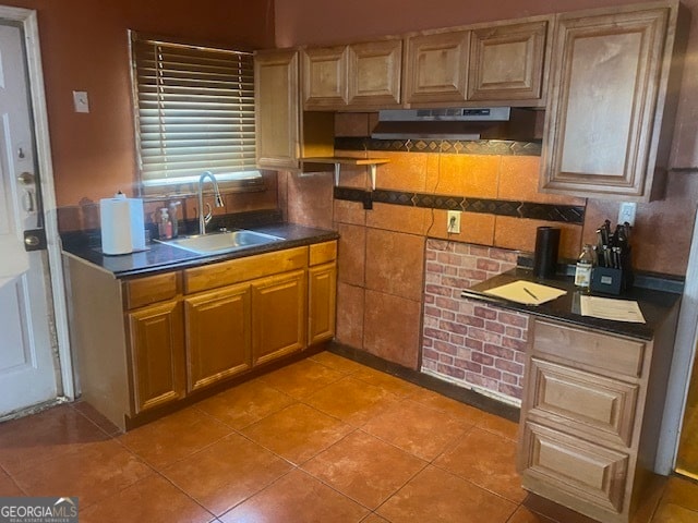 kitchen with tile patterned floors and sink