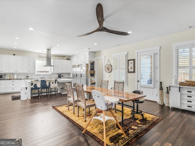 dining area featuring ceiling fan, dark hardwood / wood-style flooring, and sink