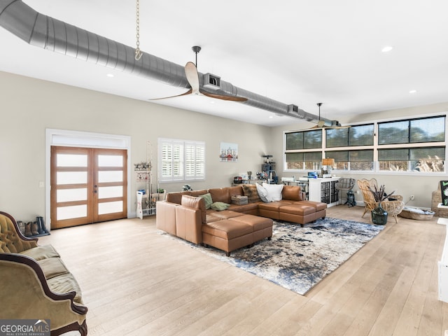 living room featuring ceiling fan, french doors, and light hardwood / wood-style flooring