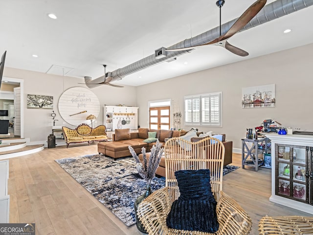 living room with light hardwood / wood-style floors and ceiling fan