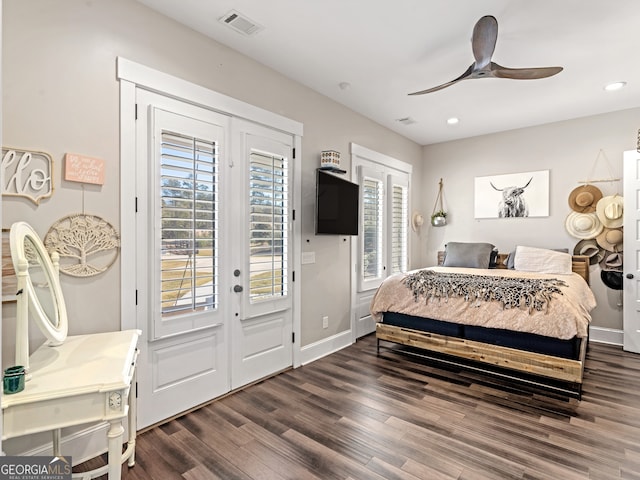 bedroom featuring multiple windows, ceiling fan, dark wood-type flooring, and access to exterior