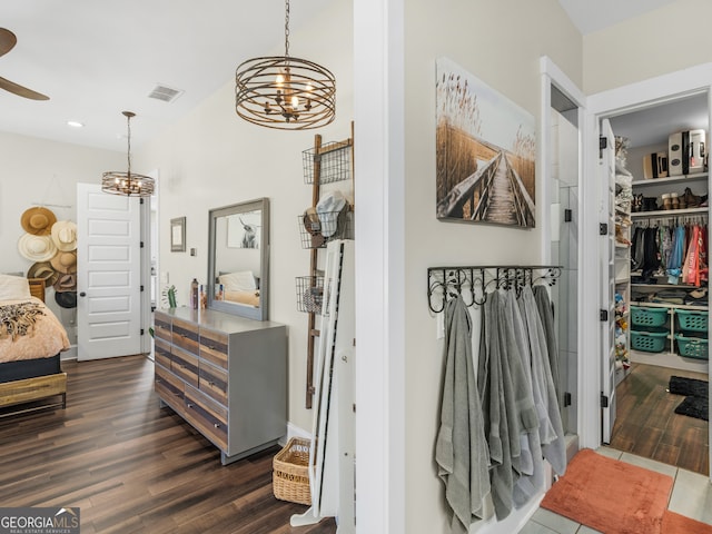 interior space with dark hardwood / wood-style floors, an inviting chandelier, and a closet