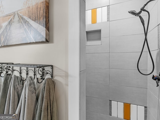 bathroom with tiled shower