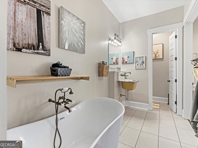 bathroom with tile patterned flooring and a bath