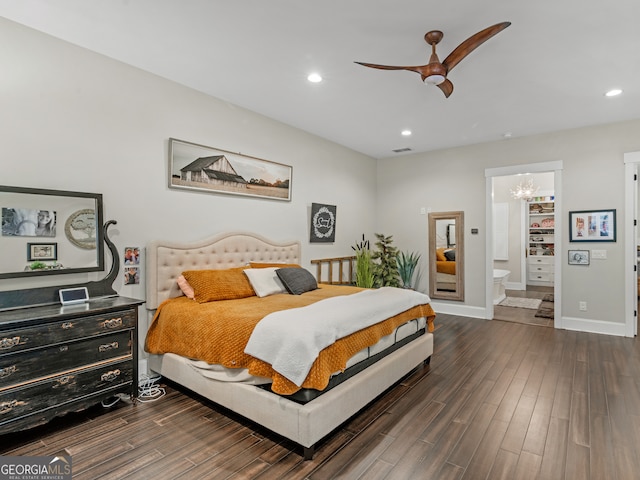 bedroom featuring ceiling fan with notable chandelier, dark hardwood / wood-style flooring, and ensuite bath