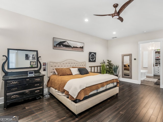 bedroom with ensuite bathroom, dark hardwood / wood-style flooring, and ceiling fan with notable chandelier