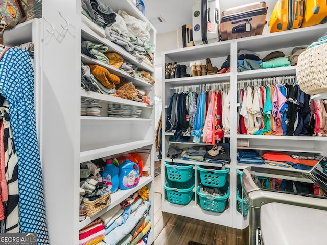 walk in closet with dark wood-type flooring