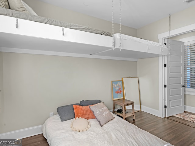 bedroom featuring dark hardwood / wood-style flooring