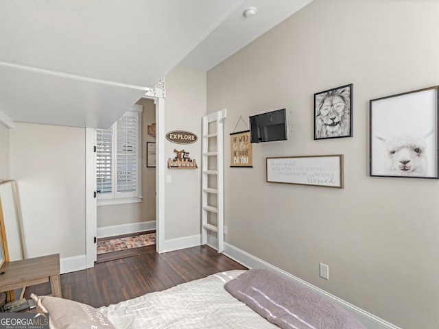 bedroom with dark wood-type flooring