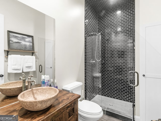 bathroom with toilet, sink, and walk in shower