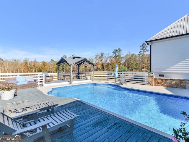 view of pool featuring a gazebo and a wooden deck