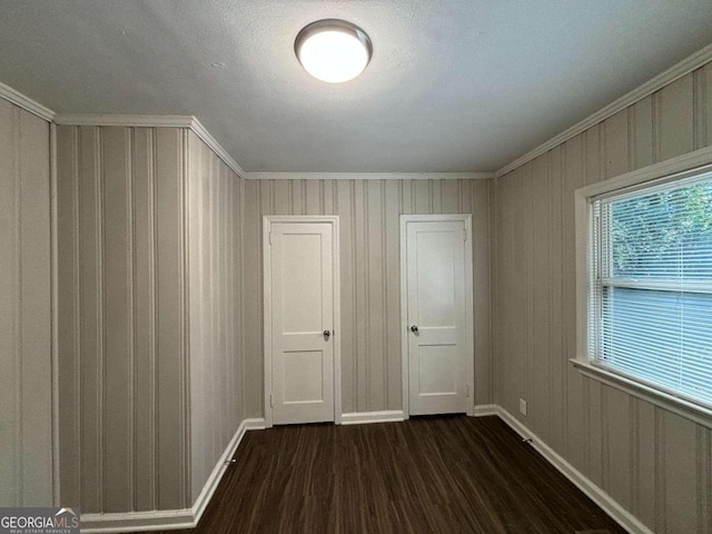 unfurnished room featuring dark hardwood / wood-style floors and a textured ceiling