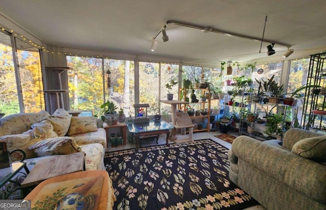 sunroom / solarium with a wealth of natural light and ceiling fan