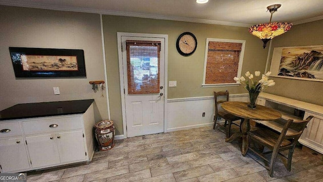 interior space featuring crown molding and light wood-type flooring