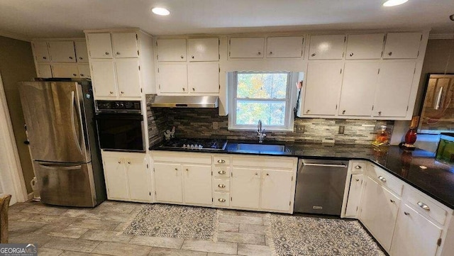 kitchen with black appliances, backsplash, white cabinetry, and sink