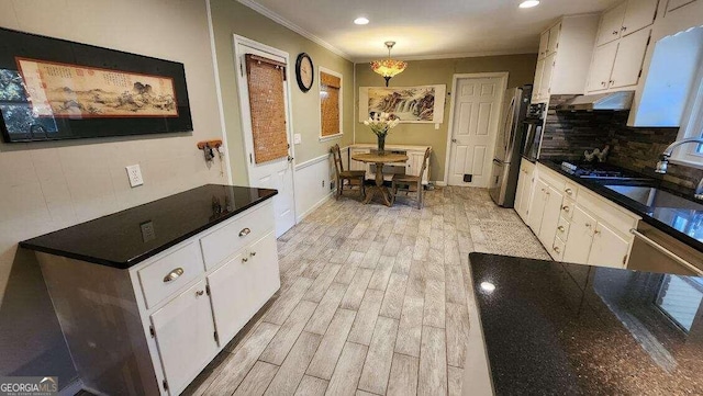 kitchen featuring white cabinets and sink