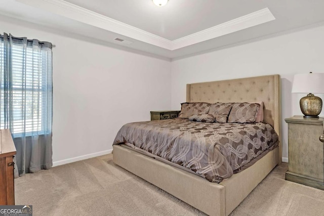 bedroom featuring a tray ceiling, crown molding, carpet flooring, baseboards, and visible vents