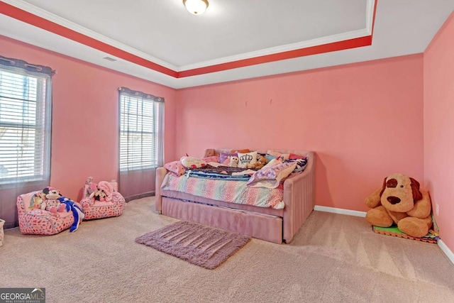 bedroom with baseboards, a tray ceiling, carpet, and crown molding