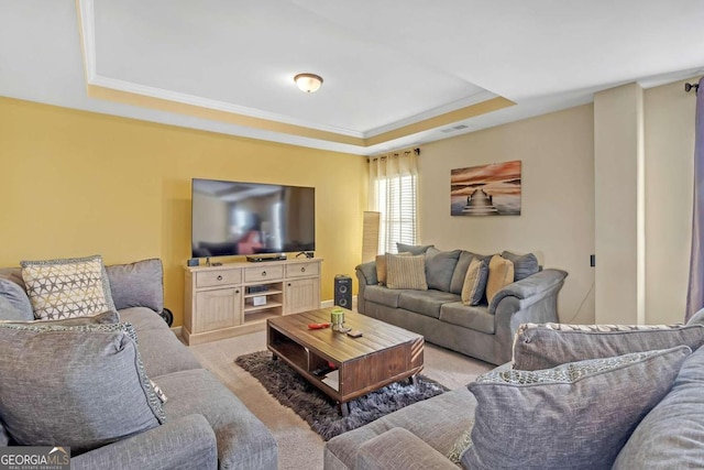 living area featuring a tray ceiling, light colored carpet, visible vents, and crown molding