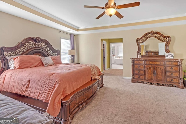 bedroom featuring light colored carpet, baseboards, ornamental molding, and a raised ceiling