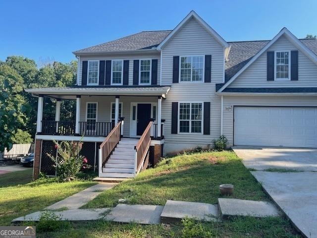 view of front facade featuring covered porch, a front lawn, and a garage