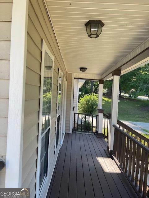 wooden terrace featuring covered porch