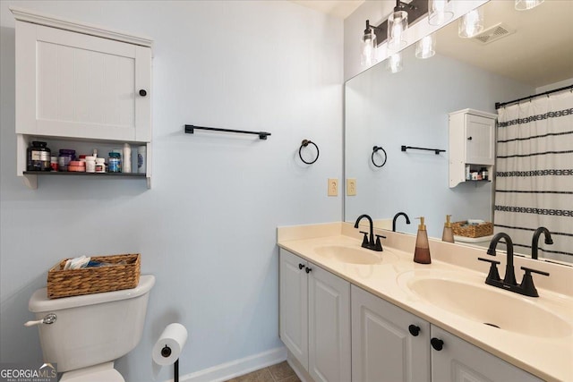 bathroom with tile patterned floors, a shower with curtain, vanity, and toilet