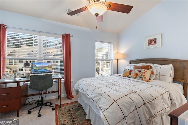 bedroom with light colored carpet, multiple windows, lofted ceiling, and ceiling fan