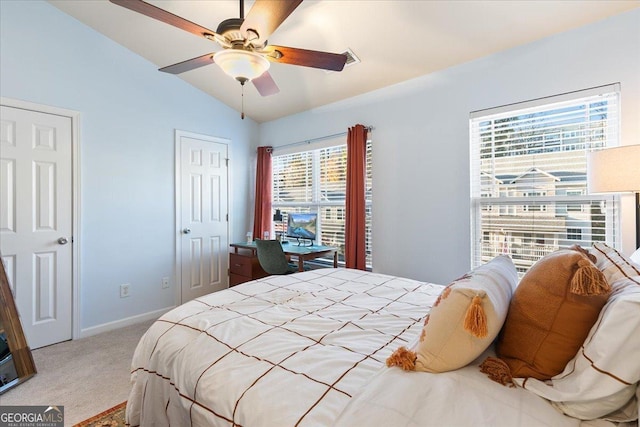 bedroom with multiple windows, ceiling fan, light colored carpet, and lofted ceiling