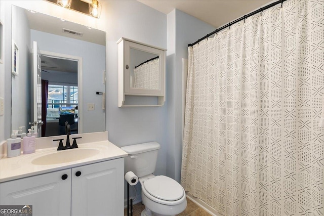 bathroom with tile patterned flooring, vanity, toilet, and a shower with shower curtain