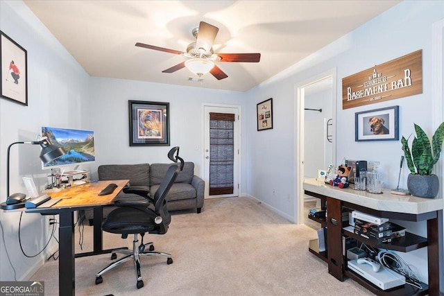 office featuring light carpet and ceiling fan