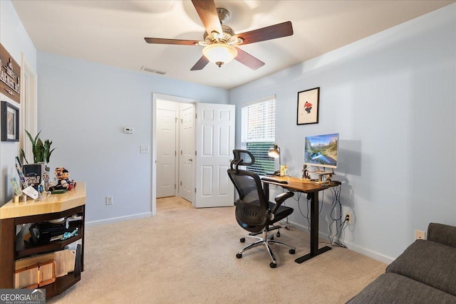 carpeted office space with ceiling fan