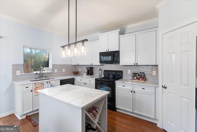 kitchen with pendant lighting, black appliances, sink, a kitchen island, and white cabinetry