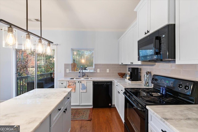 kitchen with white cabinetry, sink, dark hardwood / wood-style flooring, pendant lighting, and black appliances